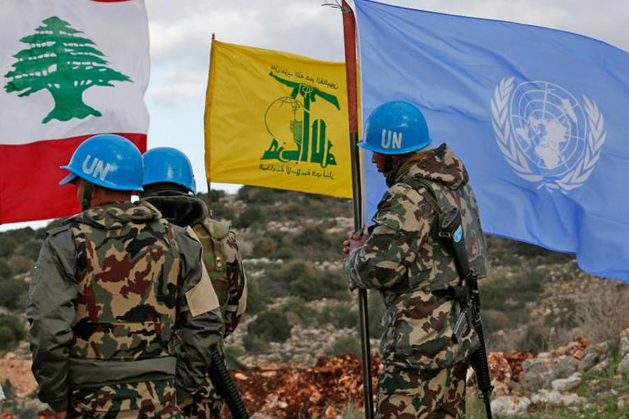 Fuerzas de la FPNUL sostienen su bandera junto a las banderas libanesas y de Hezbollah, cerca de la frontera, 13 de diciembre de 2018. Foto: Hussein Malla, AP.