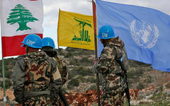 Fuerzas de la FPNUL sostienen su bandera junto a las banderas libanesas y de Hezbollah, cerca de la frontera, 13 de diciembre de 2018. Foto: Hussein Malla, AP.