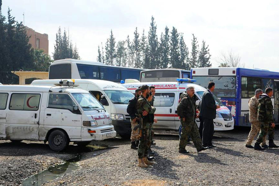 Ambulancias y micros listos frente a la entrada del corredor humanitario abierto por el Ejército Árabe Sirio para los civiles de Ghouta Oriental.