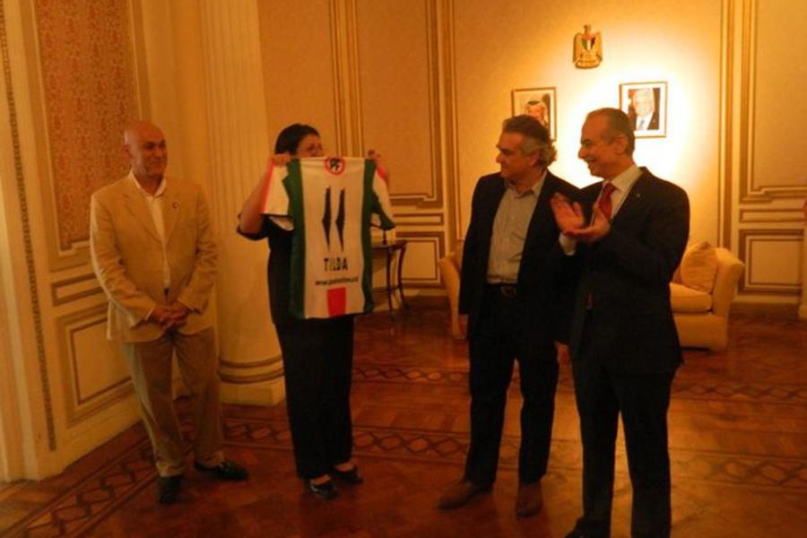 La Presidenta de la Federación de Entidades Argentino Palestinas, Tilda Rabi, recibe la camiseta del equipo, con su nombre